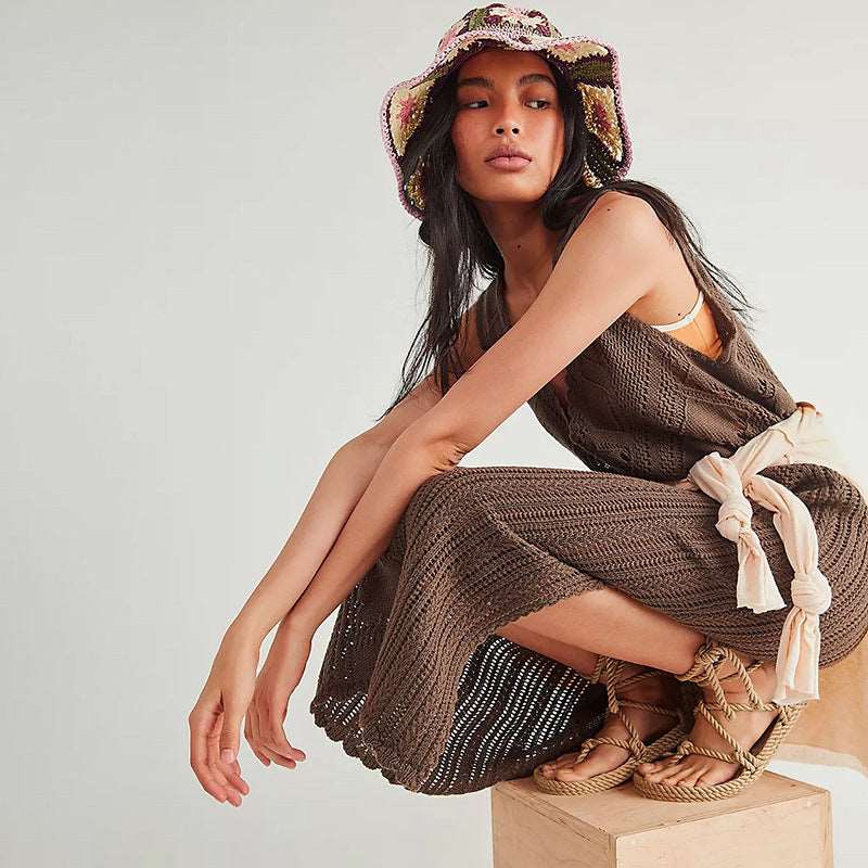 a woman in a bikini top sitting on a box 